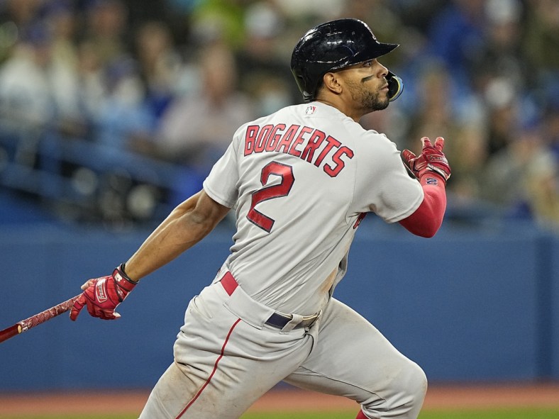 Apr 27, 2022; Toronto, Ontario, CAN; Boston Red Sox shortstop Xander Bogaerts (2) hits a single against the Toronto Blue Jays during the sixth inning at Rogers Centre. Mandatory Credit: John E. Sokolowski-USA TODAY Sports