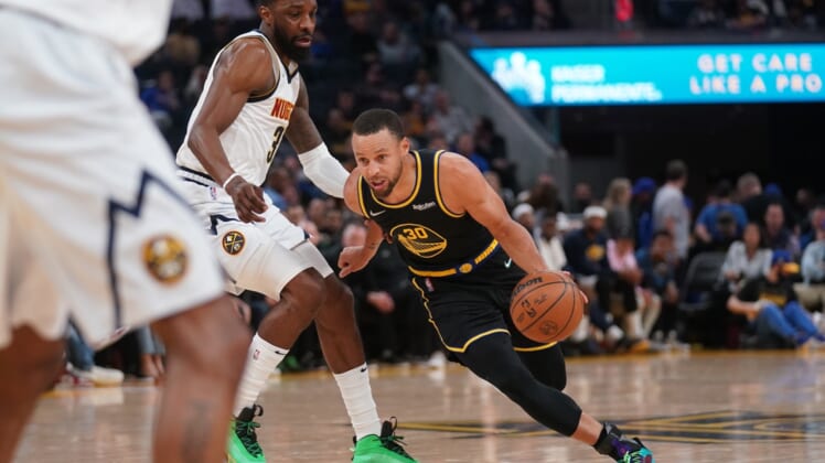 Apr 27, 2022; San Francisco, California, USA; Golden State Warriors guard Stephen Curry (30) dribbles past Denver Nuggets forward Jeff Green (32) in the second quarter during game five of the first round for the 2022 NBA playoffs at Chase Center. Mandatory Credit: Cary Edmondson-USA TODAY Sports