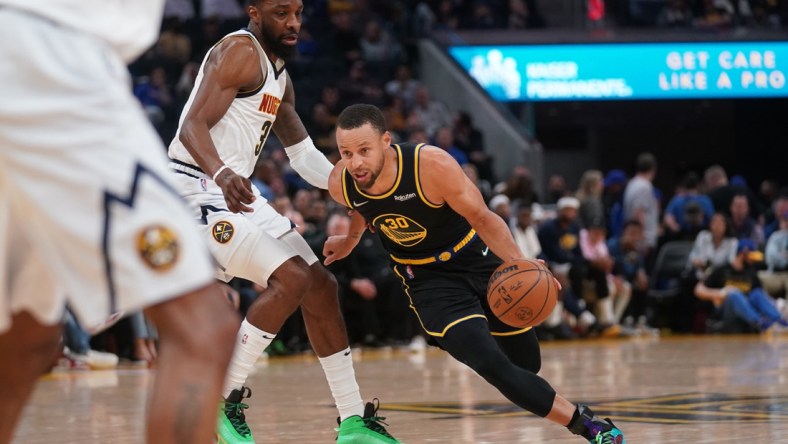 Apr 27, 2022; San Francisco, California, USA; Golden State Warriors guard Stephen Curry (30) dribbles past Denver Nuggets forward Jeff Green (32) in the second quarter during game five of the first round for the 2022 NBA playoffs at Chase Center. Mandatory Credit: Cary Edmondson-USA TODAY Sports