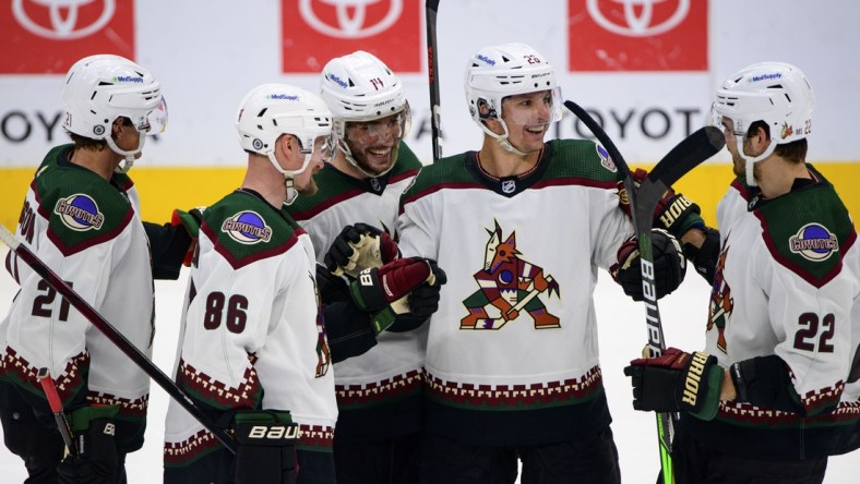 Apr 27, 2022; Dallas, Texas, USA; Arizona Coyotes left wing Loui Eriksson (21) and defenseman Anton Stralman (86) and defenseman Shayne Gostisbehere (14) and left wing Antoine Roussel (26) and center Jack McBain (22) celebrates a goal scored by Gostisbehere against the Dallas Stars during the third period at the American Airlines Center. Mandatory Credit: Jerome Miron-USA TODAY Sports