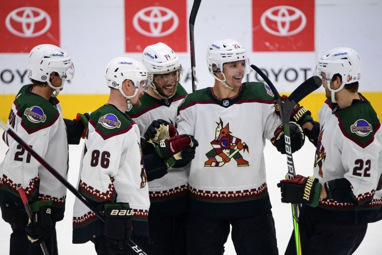 Apr 27, 2022; Dallas, Texas, USA; Arizona Coyotes left wing Loui Eriksson (21) and defenseman Anton Stralman (86) and defenseman Shayne Gostisbehere (14) and left wing Antoine Roussel (26) and center Jack McBain (22) celebrates a goal scored by Gostisbehere against the Dallas Stars during the third period at the American Airlines Center. Mandatory Credit: Jerome Miron-USA TODAY Sports