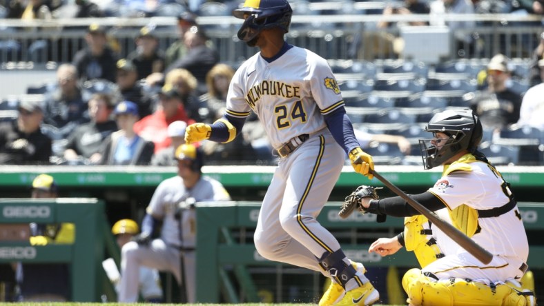 Apr 28, 2022; Pittsburgh, Pennsylvania, USA;  Milwaukee Brewers designated hitter Andrew McCutchen (24) hits a single against the Pittsburgh Pirates during the third inning at PNC Park. Mandatory Credit: Charles LeClaire-USA TODAY Sports