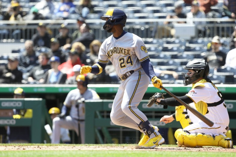 Apr 28, 2022; Pittsburgh, Pennsylvania, USA;  Milwaukee Brewers designated hitter Andrew McCutchen (24) hits a single against the Pittsburgh Pirates during the third inning at PNC Park. Mandatory Credit: Charles LeClaire-USA TODAY Sports