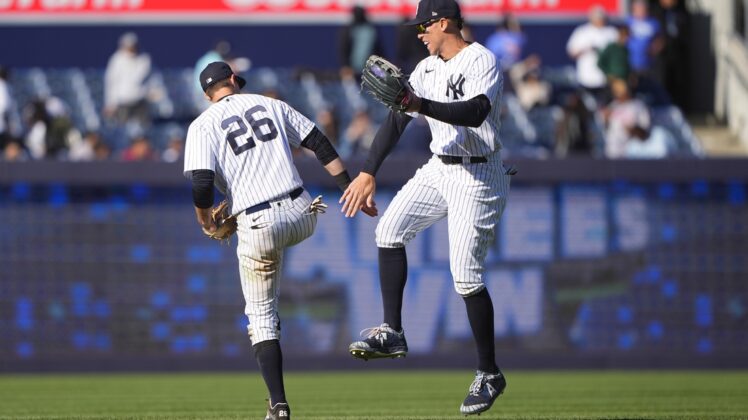 Apr 28, 2022; Bronx, New York, USA; New York Yankees second baseman DJ LeMahieu (26) and New York Yankees right fielder Aaron Judge (99) low five to celebrate the victory after the ninth inning against the Baltimore Orioles at Yankee Stadium. Mandatory Credit: Gregory Fisher-USA TODAY Sports