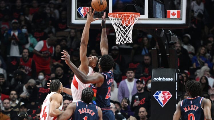 Apr 28, 2022; Toronto, Ontario, CAN;  Toronto Raptors forward Scottie Barnes (4) shoots for a basket against Philadelphia 76ers center Joel Embiid (21) in the first half during game six of the first round for the 2022 NBA playoffs at Scotiabank Arena. Mandatory Credit: Dan Hamilton-USA TODAY Sports
