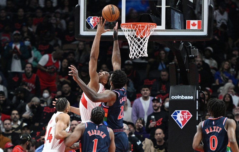 Apr 28, 2022; Toronto, Ontario, CAN;  Toronto Raptors forward Scottie Barnes (4) shoots for a basket against Philadelphia 76ers center Joel Embiid (21) in the first half during game six of the first round for the 2022 NBA playoffs at Scotiabank Arena. Mandatory Credit: Dan Hamilton-USA TODAY Sports