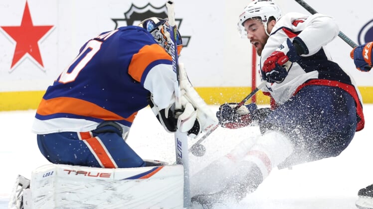 Apr 28, 2022; Elmont, New York, USA; New York Islanders goaltender Semyon Varlamov (40) makes a save against Washington Capitals right wing Tom Wilson (43) during the first period at UBS Arena. Mandatory Credit: Brad Penner-USA TODAY Sports
