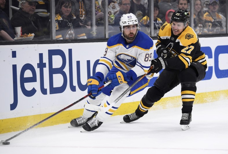Apr 28, 2022; Boston, Massachusetts, USA;  Buffalo Sabres right wing Alex Tuch (89) controls the puck against Boston Bruins defenseman Hampus Lindholm (27) during the first period at TD Garden. Mandatory Credit: Bob DeChiara-USA TODAY Sports