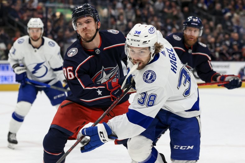 Apr 28, 2022; Columbus, Ohio, USA;  Columbus Blue Jackets center Jack Roslovic (96) high sticks Tampa Bay Lightning left wing Brandon Hagel (38) in the first period at Nationwide Arena. Jack Roslovic was penalized on the play. Mandatory Credit: Aaron Doster-USA TODAY Sports