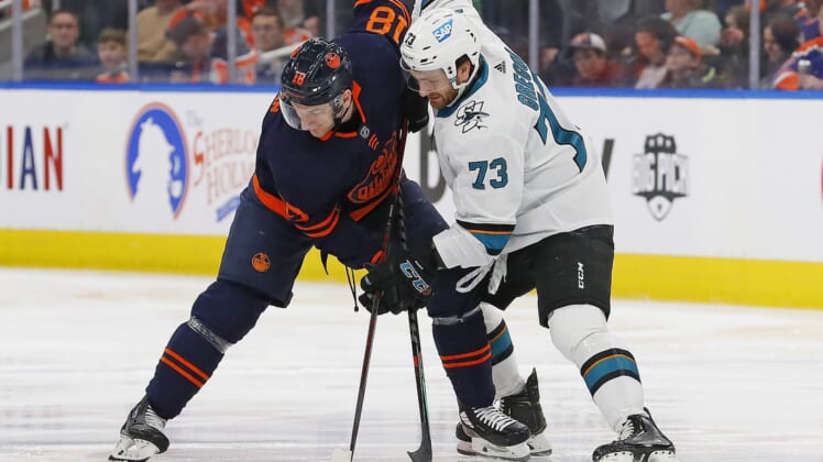 Apr 28, 2022; Edmonton, Alberta, CAN; Edmonton Oilers forward Zach Hyman (18) and San Jose Sharks forward Noah Gregor (73) battle for a loose puck during the first period at Rogers Place. Mandatory Credit: Perry Nelson-USA TODAY Sports