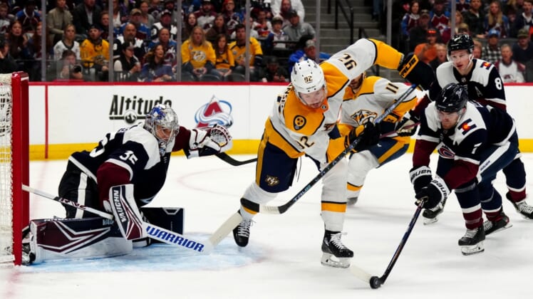 Apr 28, 2022; Denver, Colorado, USA; Colorado Avalanche defenseman Devon Toews (7) pokes the puck away from Nashville Predators center Ryan Johansen (92) and goaltender Darcy Kuemper (35) defends the net in the first period at Ball Arena. Mandatory Credit: Ron Chenoy-USA TODAY Sports