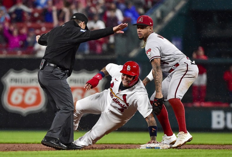 Apr 28, 2022; St. Louis, Missouri, USA;  St. Louis Cardinals catcher Yadier Molina (4) reacts after sliding safely past Arizona Diamondbacks second baseman Ketel Marte (4) for a stolen base during the sixth inning at Busch Stadium. Mandatory Credit: Jeff Curry-USA TODAY Sports