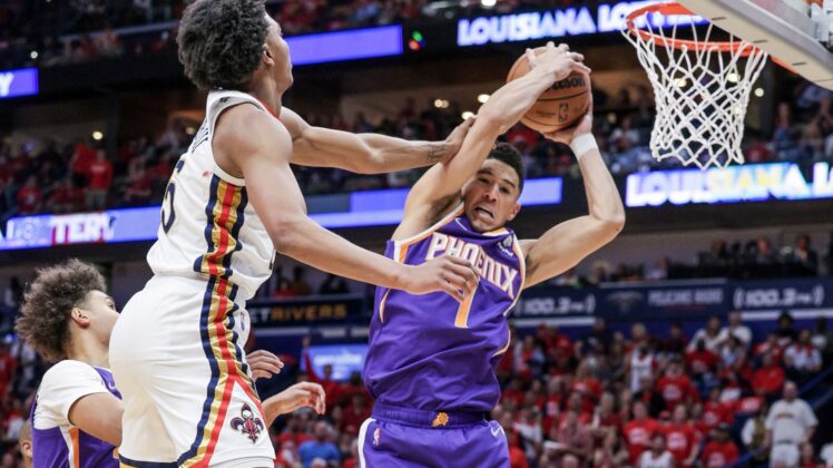 Apr 28, 2022; New Orleans, Louisiana, USA;  New Orleans Pelicans forward Herbert Jones (5) fouls Phoenix Suns guard Devin Booker (1) during the first half of game six of the first round for the 2022 NBA playoffs at Smoothie King Center. Mandatory Credit: Stephen Lew-USA TODAY Sports