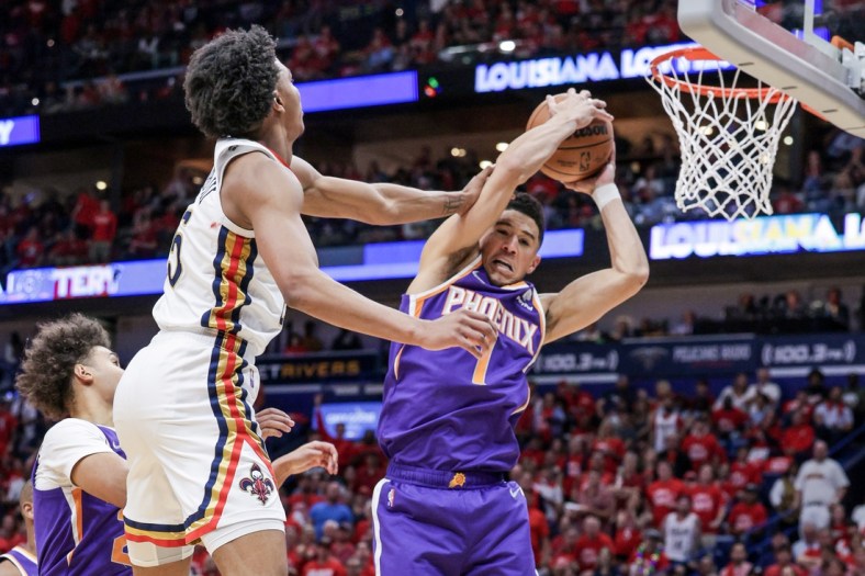 Apr 28, 2022; New Orleans, Louisiana, USA;  New Orleans Pelicans forward Herbert Jones (5) fouls Phoenix Suns guard Devin Booker (1) during the first half of game six of the first round for the 2022 NBA playoffs at Smoothie King Center. Mandatory Credit: Stephen Lew-USA TODAY Sports