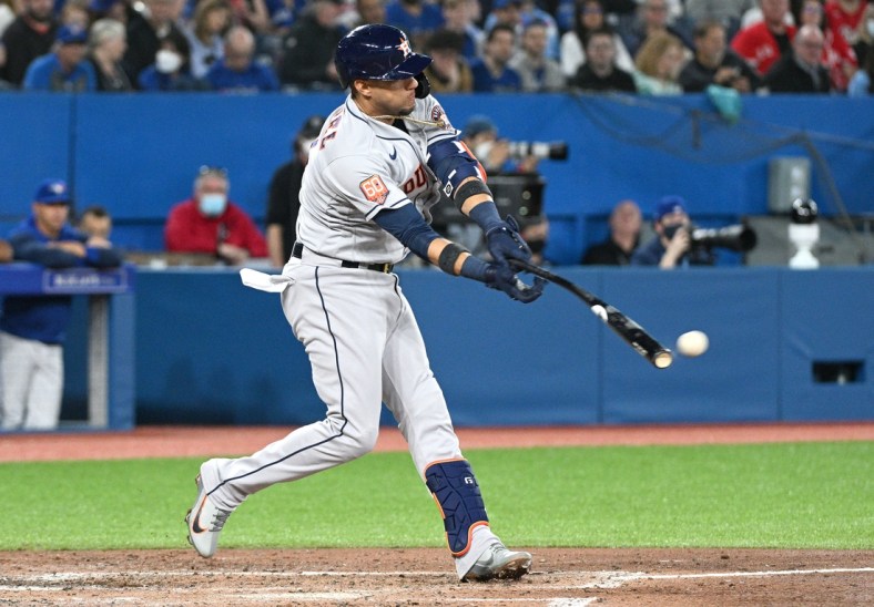 Apr 29, 2022; Toronto, Ontario, CAN;  Houston Astros first baseman Yuli Gurriel (10) hits an RBI single against the Toronto Blue Jays in the third inning at Rogers Centre. Mandatory Credit: Dan Hamilton-USA TODAY Sports