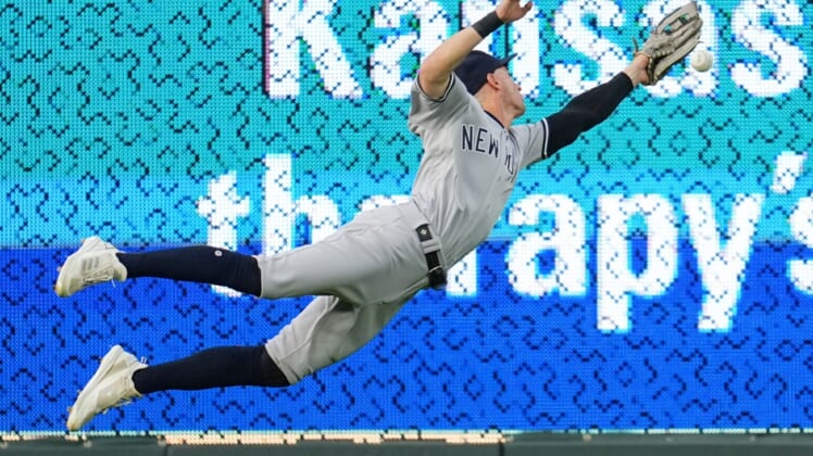 Apr 29, 2022; Kansas City, Missouri, USA; New York Yankees left fielder Tim Locastro (33) is unable to make a diving catch the first inning against the Kansas City Royals at Kauffman Stadium. Mandatory Credit: Jay Biggerstaff-USA TODAY Sports