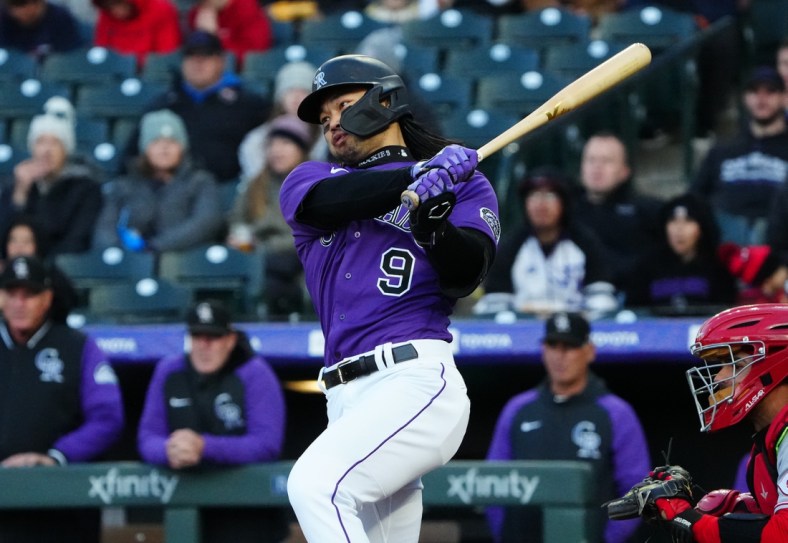 Apr 29, 2022; Denver, Colorado, USA; Colorado Rockies first baseman Connor Joe (9) singles in the first inning against the Cincinnati Reds at Coors Field. Mandatory Credit: Ron Chenoy-USA TODAY Sports