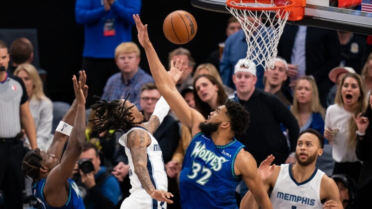 Apr 29, 2022; Minneapolis, Minnesota, USA; Memphis Grizzlies guard Ja Morant (12) shoots against the Minnesota Timberwolves center Karl-Anthony Towns (32) in the second quarter during game six of the first round for the 2022 NBA playoffs at Target Center. Mandatory Credit: Brad Rempel-USA TODAY Sports