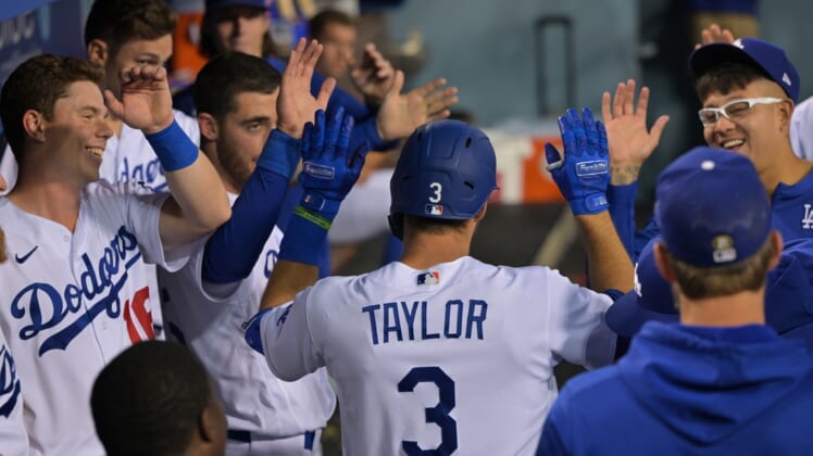 Apr 29, 2022; Los Angeles, California, USA; Los Angeles Dodgers designated hitter Chris Taylor (3) is greeted in the dugout after hitting a solo home run in the second inning against the Detroit Tigers at Dodger Stadium. Mandatory Credit: Jayne Kamin-Oncea-USA TODAY Sports