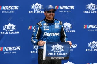 Apr 30, 2022; Dover, Delaware, USA; NASCAR Cup Series driver Chris Buescher stands with the Busch Light Pole Award after winning the pole during qualifying for the DuraMAX Drydene 400 at Dover Motor Speedway. Mandatory Credit: Matthew OHaren-USA TODAY Sports