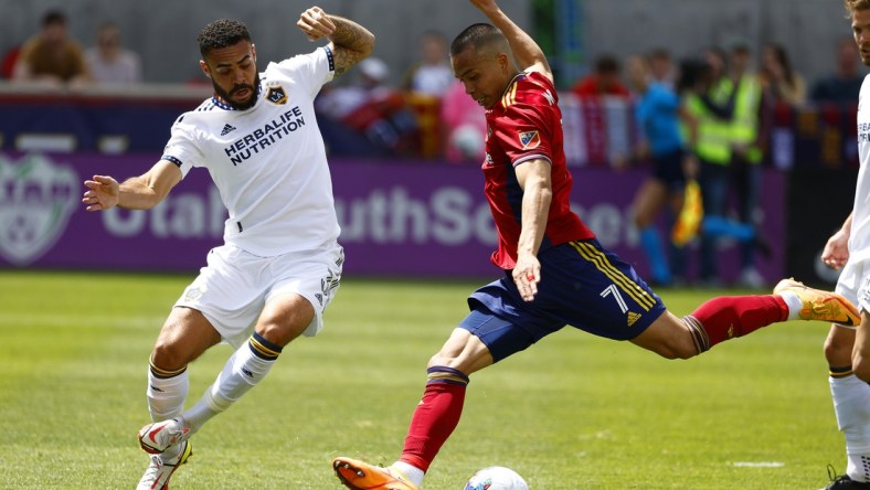 Apr 30, 2022; Sandy, Utah, USA;  Los Angeles Galaxy defender Derrick Williams (3) and Real Salt Lake forward Bobby Wood (7) battle in the first half at Rio Tinto Stadium. Mandatory Credit: Jeffrey Swinger-USA TODAY Sports