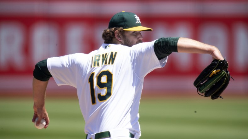 Apr 30, 2022; Oakland, California, USA; Oakland Athletics starting pitcher Cole Irvin (19) delivers a pitch against the Cleveland Guardians in the second inning at RingCentral Coliseum. Mandatory Credit: D. Ross Cameron-USA TODAY Sports