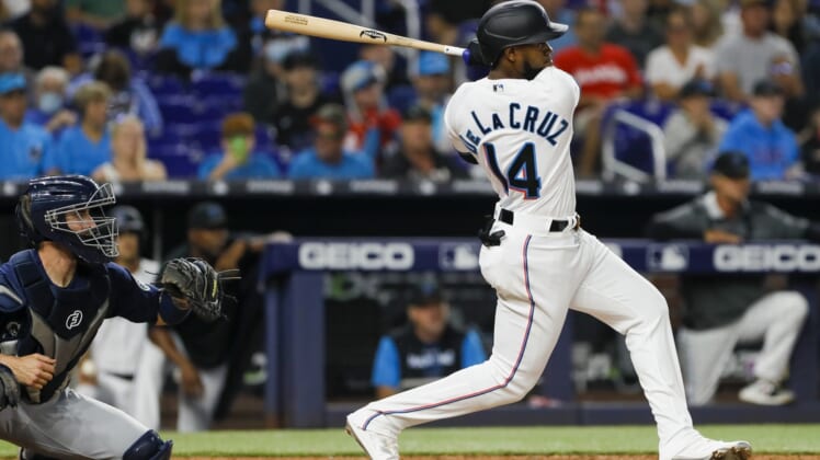 Apr 30, 2022; Miami, Florida, USA; Miami Marlins center fielder Bryan De La Cruz (14) hits an RBI single in the fifth inning against the Seattle Mariners at loanDepot Park. Mandatory Credit: Sam Navarro-USA TODAY Sports