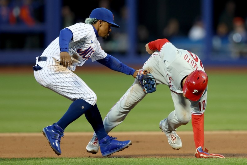 Apr 30, 2022; New York City, New York, USA; Philadelphia Phillies catcher J.T. Realmuto (10) is tagged out by New York Mets shortstop Francisco Lindor (12) on a double play hit into by left fielder Kyle Schwarber (not pictured) during the second inning at Citi Field. Mandatory Credit: Brad Penner-USA TODAY Sports