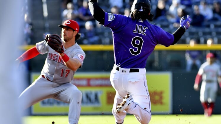 Apr 30, 2022; Denver, Colorado, USA; Colorado Rockies first baseman Connor Joe (9) attempts to steal second base during the first inning as Cincinnati Reds shortstop Kyle Farmer (17) waits for the throw at Coors Field. Mandatory Credit: John Leyba-USA TODAY Sports
