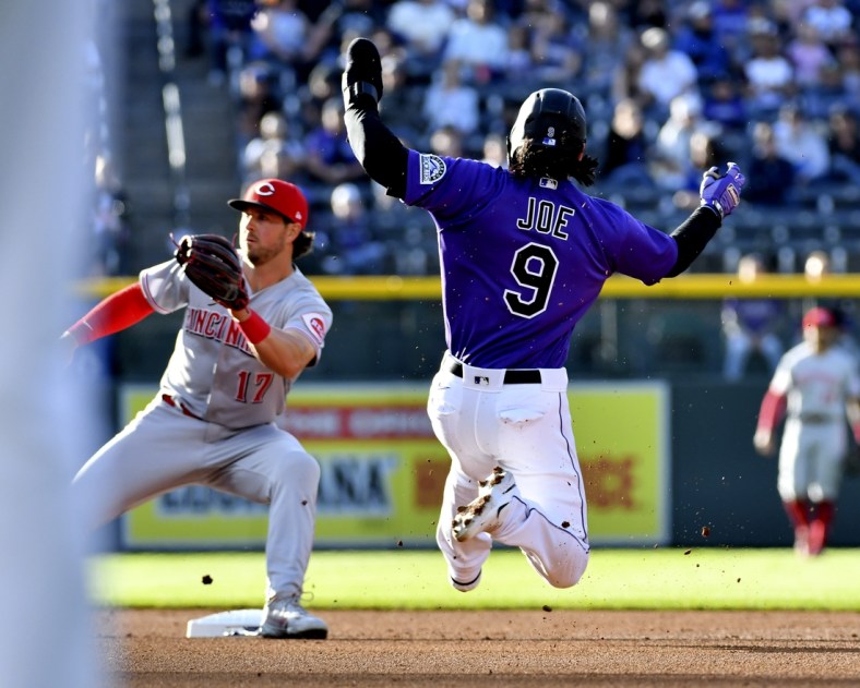 Apr 30, 2022; Denver, Colorado, USA; Colorado Rockies first baseman Connor Joe (9) attempts to steal second base during the first inning as Cincinnati Reds shortstop Kyle Farmer (17) waits for the throw at Coors Field. Mandatory Credit: John Leyba-USA TODAY Sports