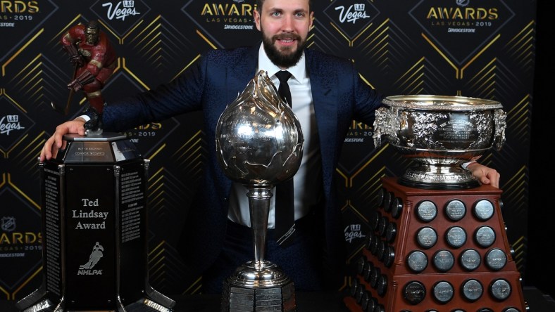 Jun 19, 2019; Las Vegas, NV, USA; Nikita Kucherov is pictured with the Ted Lindsay award, Art Ross trophy, and Hart trophy during the 2019 NHL Awards at Mandalay Bay. Mandatory Credit: Stephen R. Sylvanie-USA TODAY Sports