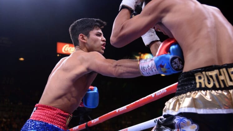 Nov 2, 2019; Las Vegas, NV, USA; Ryan Garcia (blue trunks) and Romero Duno (black trunks) box during their WBC silver and NABO lightweight title bout at MGM Grand Garden Arena. Garcia won via first round TKO. Mandatory Credit: Joe Camporeale-USA TODAY Sports