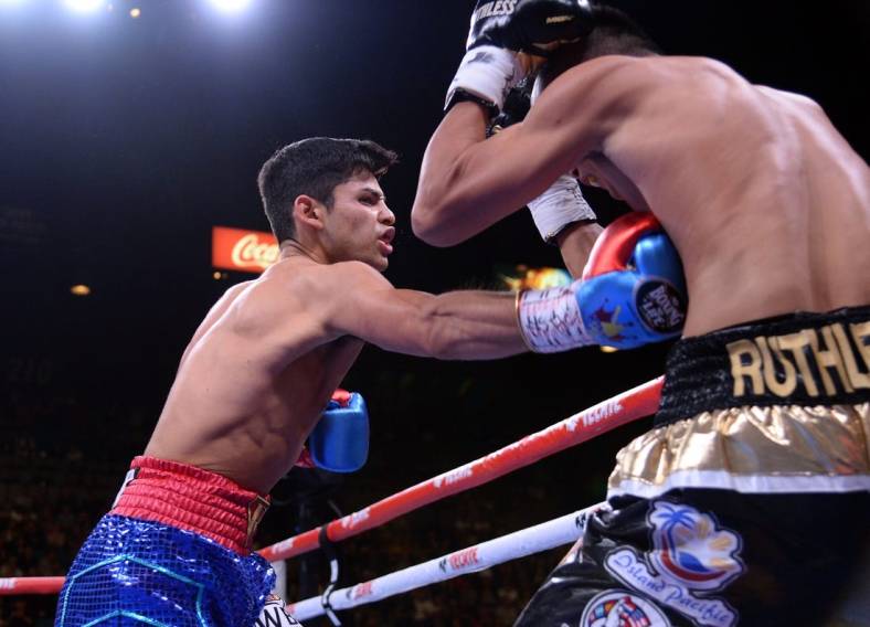 Nov 2, 2019; Las Vegas, NV, USA; Ryan Garcia (blue trunks) and Romero Duno (black trunks) box during their WBC silver and NABO lightweight title bout at MGM Grand Garden Arena. Garcia won via first round TKO. Mandatory Credit: Joe Camporeale-USA TODAY Sports