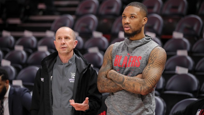 Feb 7, 2020; Salt Lake City, Utah, USA; Portland Trail Blazers guard Damian Lillard (0) talks with his Weber State head coach Randy Rahe before the game against the Utah Jazz at Vivint Smart Home Arena. Mandatory Credit: Chris Nicoll-USA TODAY Sports