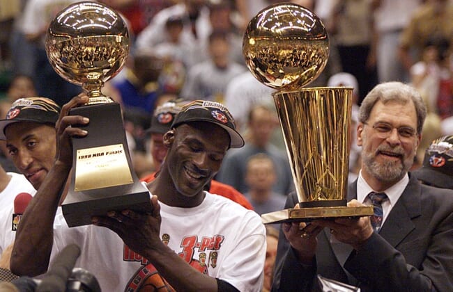 Michael Jordan and Phil Jackson celebrate after finishing off the Jazz to win the 1998 championship.2020-04-16 Jordan Jackson