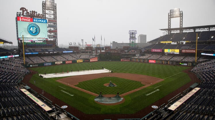 Aug 29, 2020; Philadelphia, Pennsylvania, USA; The grounds crew cover the field during a rain delay in seventh inning of a game between the Philadelphia Phillies and the Atlanta Braves at Citizens Bank Park. Mandatory Credit: Bill Streicher-USA TODAY Sports