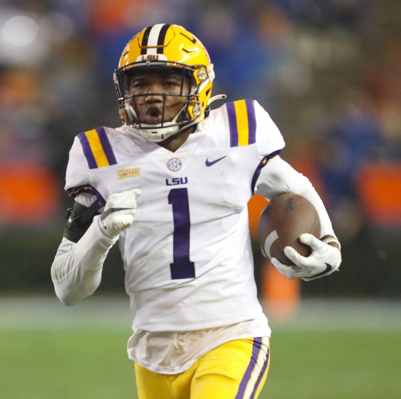 Dec 12, 2020; Gainesville, FL, USA;  LSU defensive back Eli Ricks (1) runs with the ball after making an interception during a game against the Florida Gators  at Ben Hill Griffin Stadium in Gainesville, Fla. Dec. 12, 2020.   Mandatory Credit: Brad McClenny-USA TODAY NETWORK