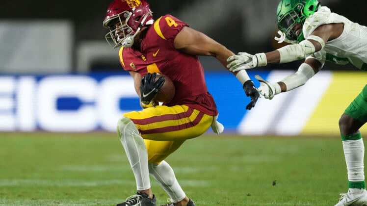 Dec 18, 2020; Los Angeles, California, USA; Southern California Trojans wide receiver Bru McCoy (4) is defended by Oregon Ducks cornerback Mykael Wright (2) during the Pac-12 Championship at United Airlines Field at Los Angeles Memorial Coliseum. Oregon defeated USC 31-24. Mandatory Credit: Kirby Lee-USA TODAY Sports