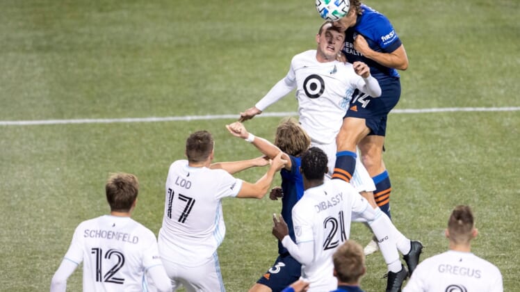 FC Cincinnati defender Nick Hagglund (14) heads the ball over Minnesota United defender Chase Gasper (77) in the second half of the MLS match between FC Cincinnati and Minnesota United at Nippert Stadium in Cincinnati.Minnesota United At Fc Cincinnati