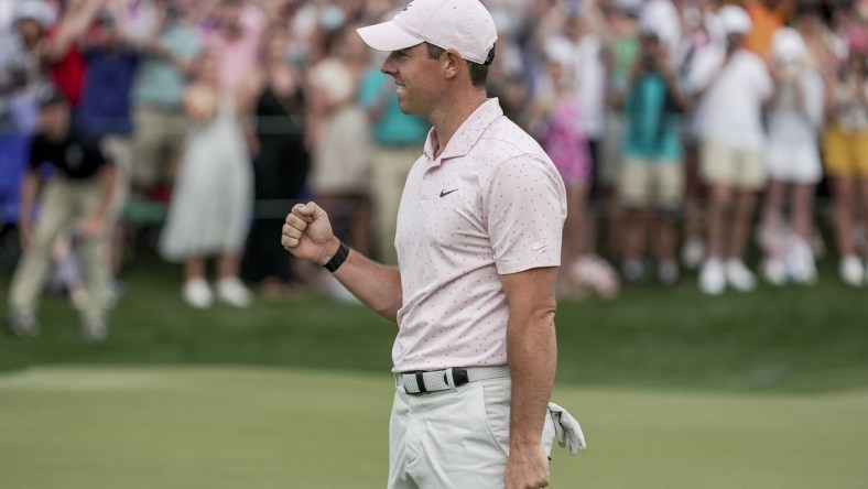 May 9, 2021; Charlotte, North Carolina, USA; Rory McIlroy gives a fist bump after securing his third Wells Fargo championship during the final round of the Wells Fargo Championship golf tournament. Mandatory Credit: Jim Dedmon-USA TODAY Sports