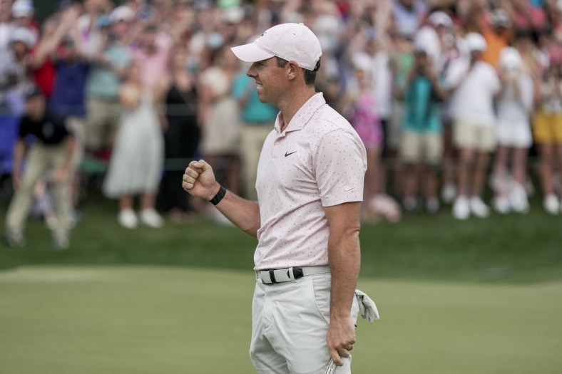 May 9, 2021; Charlotte, North Carolina, USA; Rory McIlroy gives a fist bump after securing his third Wells Fargo championship during the final round of the Wells Fargo Championship golf tournament. Mandatory Credit: Jim Dedmon-USA TODAY Sports