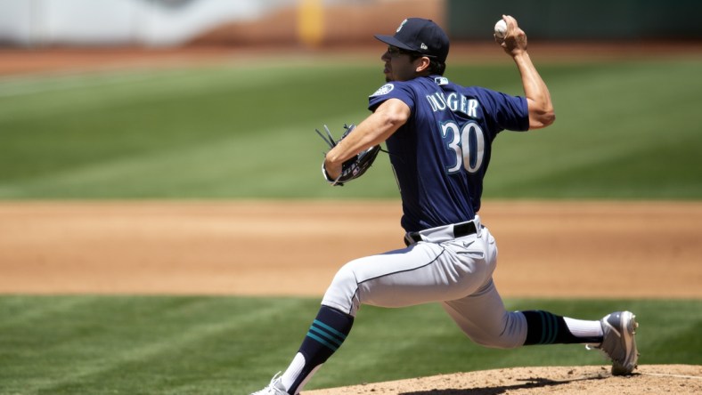 May 26, 2021; Oakland, California, USA; Seattle Mariners starting pitcher Robert Dugger (30) delivers a pitch against the Oakland Athletics during the third inning at RingCentral Coliseum. Mandatory Credit: D. Ross Cameron-USA TODAY Sports