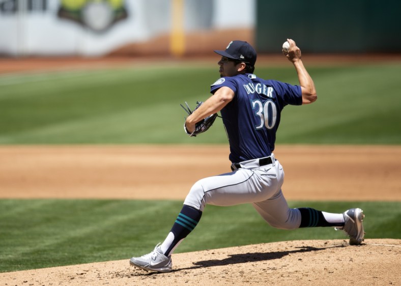 May 26, 2021; Oakland, California, USA; Seattle Mariners starting pitcher Robert Dugger (30) delivers a pitch against the Oakland Athletics during the third inning at RingCentral Coliseum. Mandatory Credit: D. Ross Cameron-USA TODAY Sports