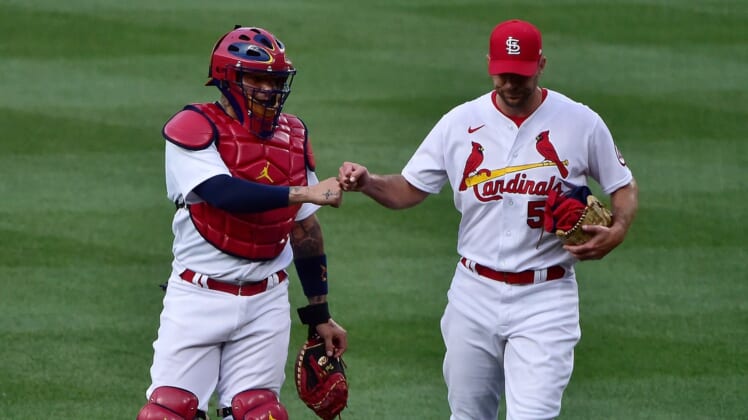 Jun 14, 2021; St. Louis, Missouri, USA;  St. Louis Cardinals catcher Yadier Molina (4) and starting pitcher Adam Wainwright (50) walk in from the bullpen prior to a game against the Miami Marlins at Busch Stadium. Mandatory Credit: Jeff Curry-USA TODAY Sports