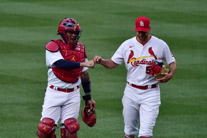 Jun 14, 2021; St. Louis, Missouri, USA;  St. Louis Cardinals catcher Yadier Molina (4) and starting pitcher Adam Wainwright (50) walk in from the bullpen prior to a game against the Miami Marlins at Busch Stadium. Mandatory Credit: Jeff Curry-USA TODAY Sports