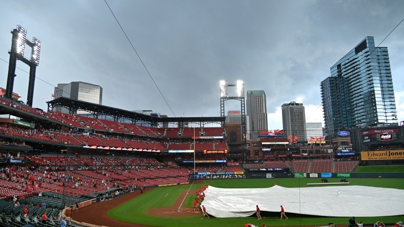 Jun 27, 2021; St. Louis, Missouri, USA;  St. Louis Cardinals grounds crew places the tarp on the field during a rain delay in the sixth inning against the Pittsburgh Pirates at Busch Stadium. Mandatory Credit: Jeff Curry-USA TODAY Sports