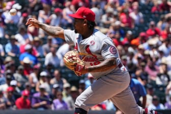 Jul 4, 2021; Denver, Colorado, USA; St. Louis Cardinals starting pitcher Carlos Martinez (18) delivers a pitch in the second inning against the Colorado Rockies at Coors Field. Mandatory Credit: Ron Chenoy-USA TODAY Sports