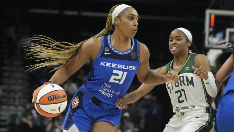 Aug 12, 2021; Phoenix, Arizona, USA; Connecticut Sun guard/forward DiJonai Carrington (left) drives against Seattle Storm guard Jordin Canada (right) in the second half during the Inaugural WNBA Commissioners Cup Championship Game at Footprint Center. Mandatory Credit: Rick Scuteri-USA TODAY Sports