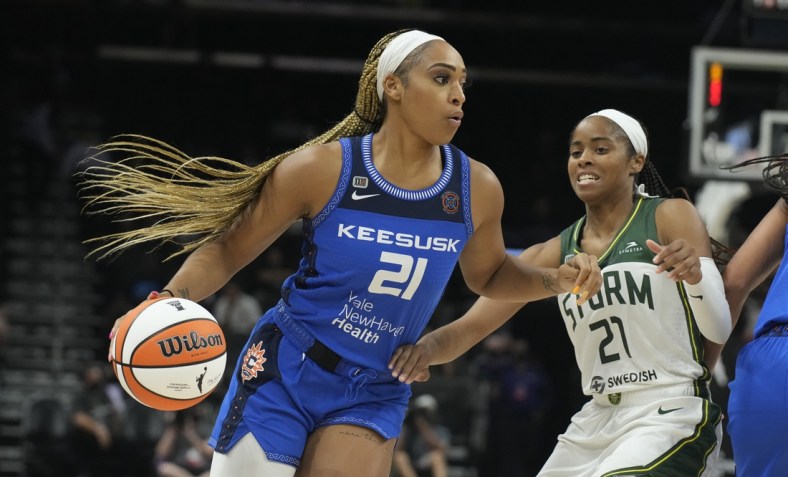 Aug 12, 2021; Phoenix, Arizona, USA; Connecticut Sun guard/forward DiJonai Carrington (left) drives against Seattle Storm guard Jordin Canada (right) in the second half during the Inaugural WNBA Commissioners Cup Championship Game at Footprint Center. Mandatory Credit: Rick Scuteri-USA TODAY Sports