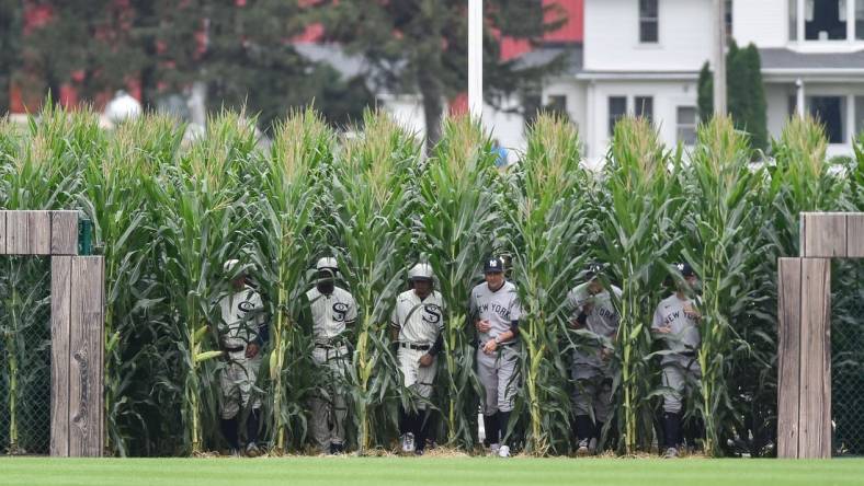 Aug 12, 2021; Dyersville, Iowa, USA; Members of the Chicago White Sox and New York Yankees enter the field before the game at Field of Dreams. Mandatory Credit: Jeffrey Becker-USA TODAY Sports